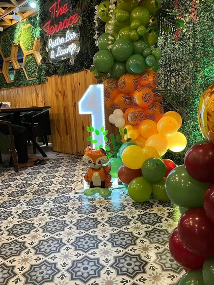 A light-up number '1' and a cute fox prop, adding to the 'Wild One' theme.