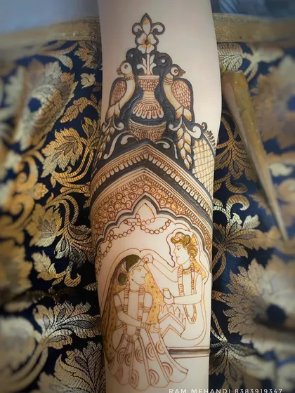 A beautiful bridal arm design featuring a sindoor ceremony. The scene is framed by an intricate archway and peacock motifs, creating an elegant and traditional look.