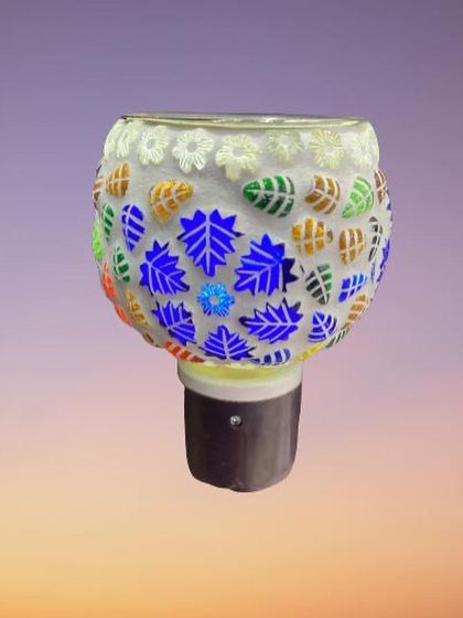 This design features a pattern of blue, green, and brown leaves against a white background. When lit, the blue leaves glow brightly, making it a striking piece of functional art for your wall.