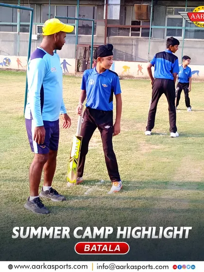 A coach provides guidance to a young batsman during the summer camp. This mentorship is a crucial part of our program.