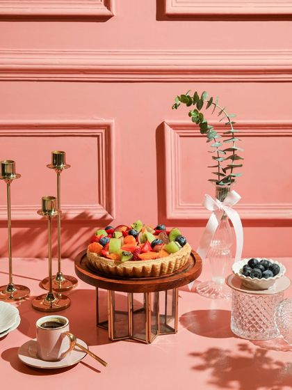 Our fresh fruit tart, a colourful and delicious dessert, set on an elegant pink table.