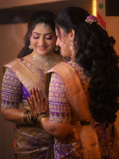 A bride looking at her reflection in a mirror. This intimate moment captures the beauty and emotion of her wedding day.