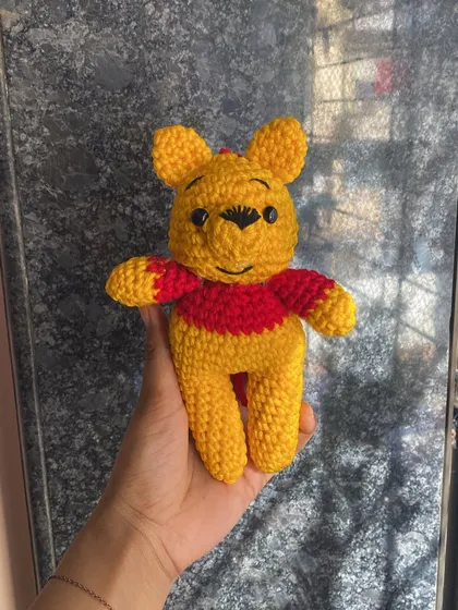 Another photo of the classic Pooh doll, a timeless character that brings a smile to everyone's face.