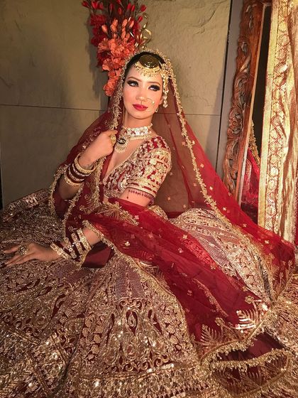 This angle showcases the beautiful draping of the dupatta and how the makeup ties the entire look together, from the maang tikka to the bold red lip.