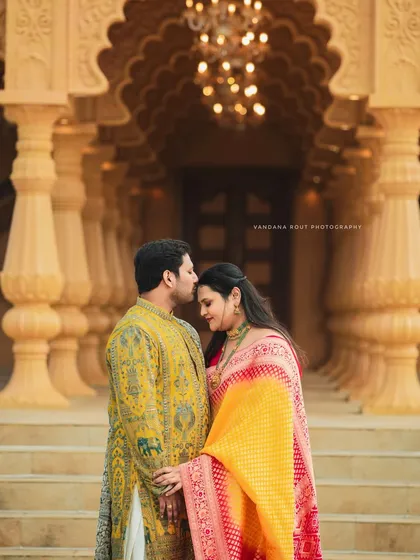 Dressed in elegant ethnic wear, this couple's pre-wedding shoot at a heritage location combines tradition with grandeur. The intricate architecture provides a timeless backdrop for their portraits.