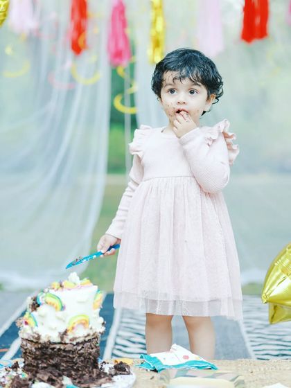 A candid photo of a little girl enjoying her birthday cake. My cake smash photography captures the fun and innocence of this messy and joyful tradition.