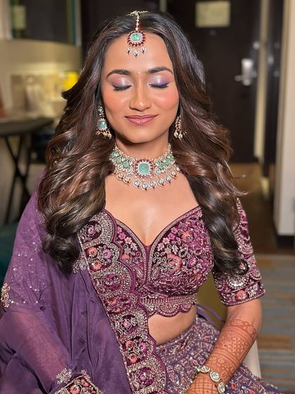 A candid shot of the bride with her eyes closed, showcasing her beautiful makeup and the details of her rental jewellery.