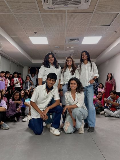 The "Jattiye Ni" crew posing after their awesome performance. The audience in the background shows the supportive community vibe of our Dance Korner events.