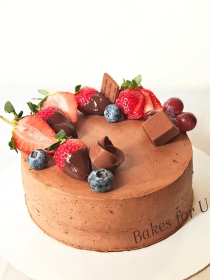 This chocolate mousse cake is topped with fresh berries. I've included chocolate-dipped strawberries, fresh blueberries, and small chocolate pieces for a rich and fruity dessert.