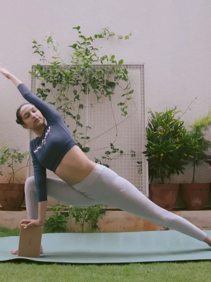 Using props isn't a shortcut, it's a smart way to practice. Here, I'm using a yoga block in Parsvakonasana (Extended Side Angle Pose) to ensure proper alignment and a deeper, safer stretch. In my one-on-one sessions, we use props to make poses work for your body.