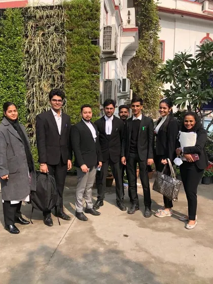 The team outside the court, a mix of senior and junior advocates ready for the day's work.