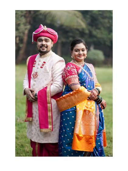 A classic back-to-back pose, showcasing the couple's elegant traditional outfits.