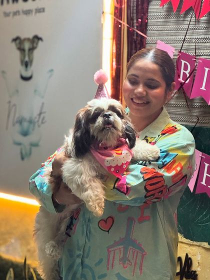 A close-up of the birthday girl in her party hat and bandana. She looks so proud!