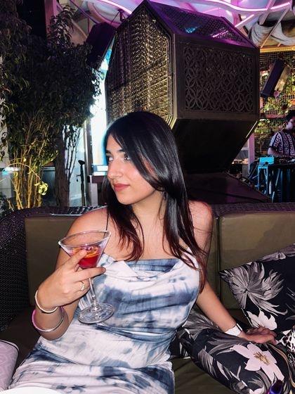 Enjoying a martini at Veu. This is a classic shot that showcases the cocktail menu and the sophisticated atmosphere.