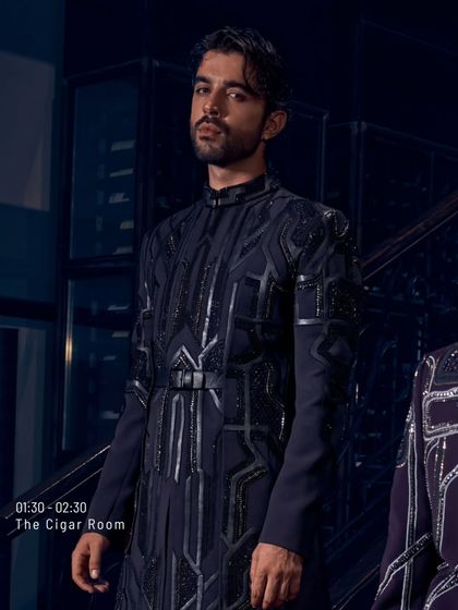Midnight tailored, memories handcrafted. This belted jacket with its pleated details and geometric embroidery is for the man whose walk says everything long before he speaks.