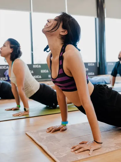 Students lifting their hearts in Cobra Pose (Bhujangasana). This gentle backbend is perfect for strengthening the spine and opening the chest.