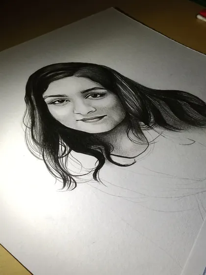 A work-in-progress shot of a commission. You can see how I build up the layers of graphite to create realistic hair and facial features.