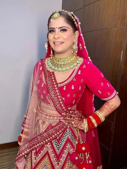 A beautiful bridal look for the sweet Gunjan. We paired her vibrant pink lehenga with a fresh, dewy makeup look and a sleek hairstyle.