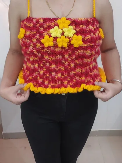 A full-length view of the Daisy Babe Top, showing how the bright colors and floral details make it a true statement piece.