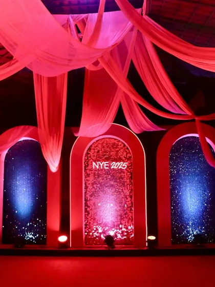 Another custom-designed photo point with three arched backdrops. The central arch featured a cascading water effect, while the side arches had a starry night effect, all bathed in dramatic red lighting.