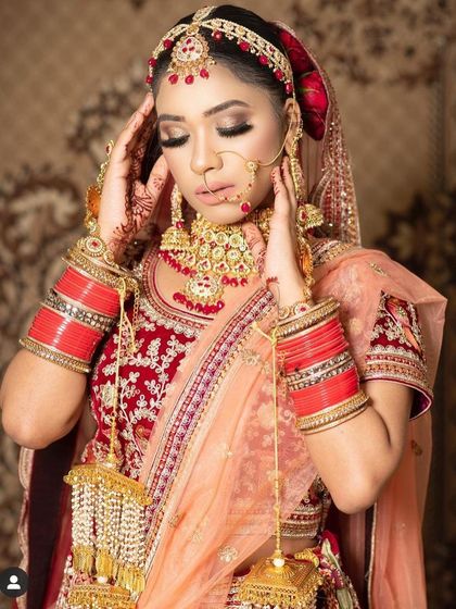 A beautiful candid moment of a bride in her rental lehenga and jewellery. The intricate details of the outfit and accessories are perfect for detailed wedding photography.