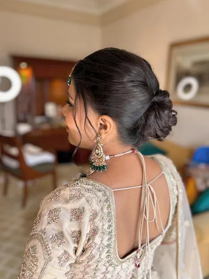 A detailed look at this bride's elegant wedding style, from her flawless makeup to her intricate floral bun.