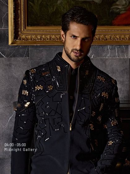 Where every thread means business. This black jacket with geometric gold embroidery is worn like a second skin. It is for the man who is not here to blend in, but to stand out.