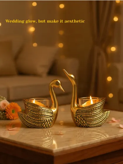 A pair of my brass swan t-light holders, bringing a sense of grace and romance to the setting. They are a beautiful symbol of togetherness, perfect for a wedding celebration.