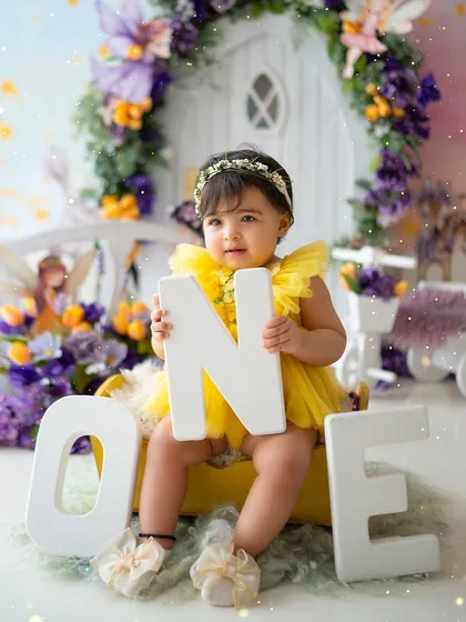 Proudly holding the letters O-N-E for her first birthday portrait.