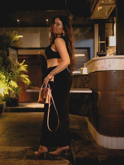 Channeling my inner Bollywood heroine with this all-black cut-out dress. It's a look straight out of a 2000s movie, perfect for a night out.