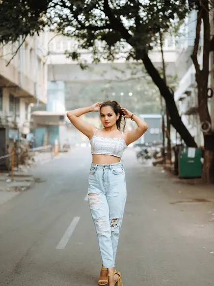 A full-length shot of a model walking down an empty street. This captures a sense of movement and style, perfect for a fashion editorial.