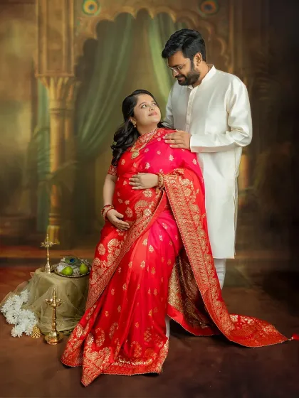 A beautiful portrait of you both, seated together in traditional attire. The loving gaze you share speaks volumes about your shared excitement and joy.