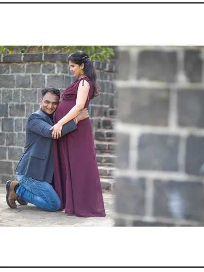 A joyful and loving dad-to-be embraces his partner's baby bump.