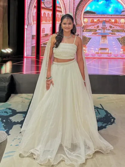 Dressed for a Sangeet night with a stunning palace-themed LED backdrop. I always coordinate my attire to match the grandeur and theme of the wedding.