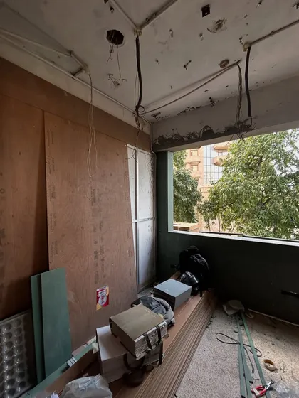 A behind the scenes shot of a room under construction, with plywood and wiring exposed. This is where the vision begins to take physical form.