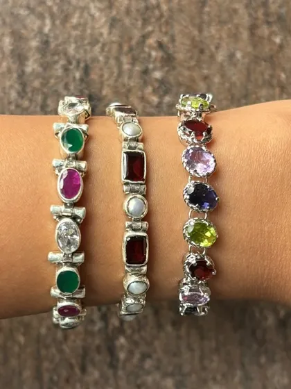 A glimpse of our popular silver stone bracelets stacked on the wrist. We offer a variety of designs featuring semi-precious stones like emerald, ruby, amethyst, and pearl, perfect for adding a pop of colour to any outfit.