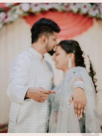 A sweet and playful pose after the ring exchange. The groom pointing to the ring adds a touch of fun and draws attention to the symbol of their commitment.