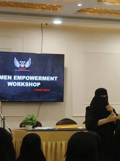 A speaker at our Women Empowerment Workshop addresses the attendees. These seminars are a crucial part of the program, focusing on building mental fortitude and a strong, confident mindset.