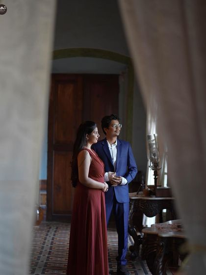 A creatively framed shot of the couple, viewed through a doorway. This technique adds depth and a sense of intimacy to the portrait.