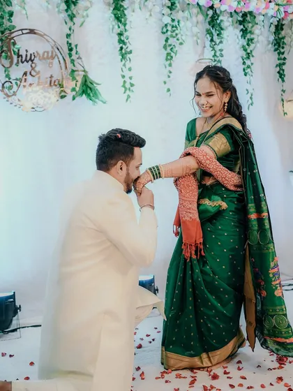 Another angle of the groom kissing his bride's hand, showing her happy reaction. It’s a classic, romantic moment that never fails to make a beautiful photograph.