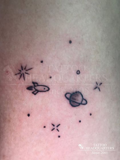 A tiny galaxy of minimalist symbols, including a rocket, a planet, and stars, creating a small cosmic scene.