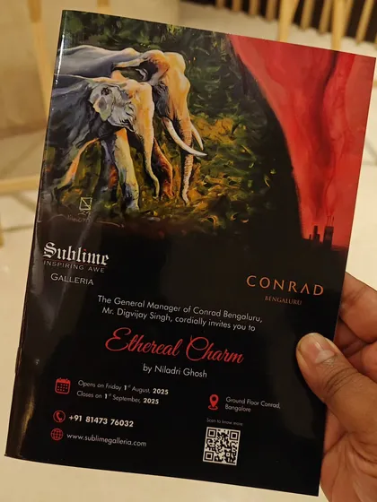 A close up of the brochure for 'Ethereal Charm' by Niladri Ghosh at Conrad Bengaluru, held by an attendee. We ensure high quality print materials for all our shows.