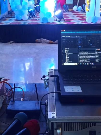 A view from my DJ station during a birthday party. I use professional DJ software on my laptop, connected to my controller and wireless microphone system, giving me full control over the music and announcements.