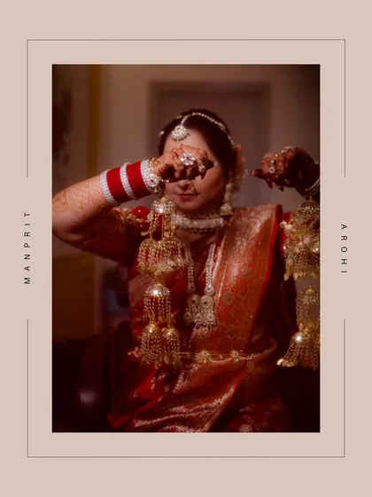 A portrait of the Punjabi bride, her face adorned with traditional 'kalire'. This shot highlights the beautiful customs of her culture, which were celebrated alongside the Odia traditions of the groom.