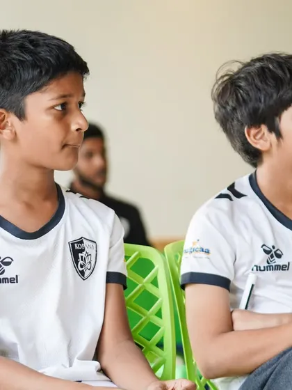 Our players listen intently during a classroom session at the camp, learning about the tactical and mental aspects of the game from seasoned professionals.