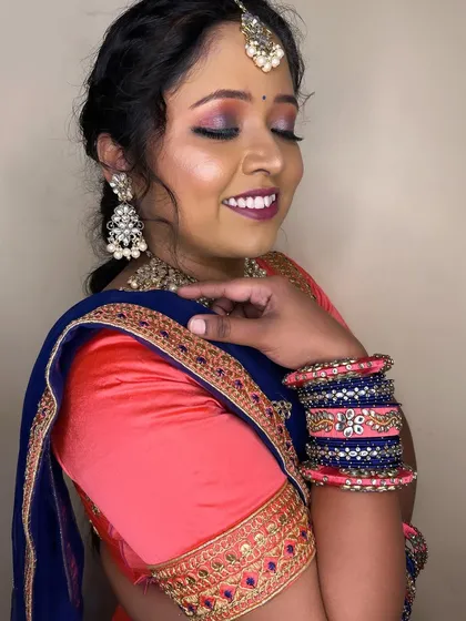A close-up of the eye makeup, featuring a blend of pink and silver shimmer. It's a fun and glamorous look for any wedding function.
