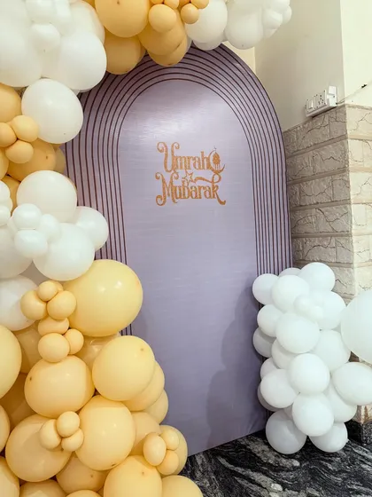 A detailed shot of the 'Umrah Mubarak' lettering on the purple arch backdrop, showing the quality of the custom print work I provide.