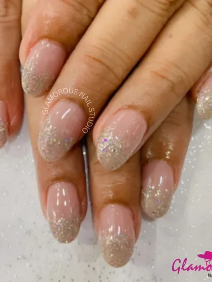A classic and elegant way to wear glitter. This design features a beautiful fade from a heavy, sparkling glitter at the tip to a soft, natural nude at the base. It's a timeless look that's perfect for any occasion.