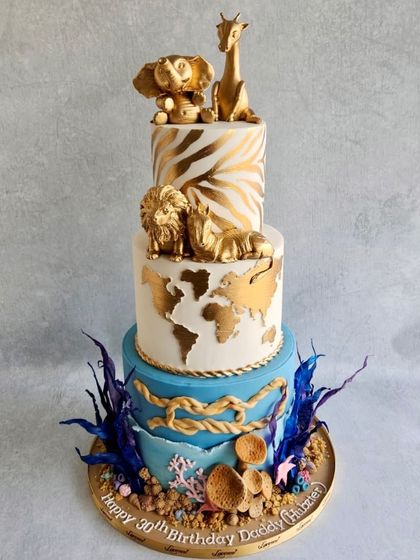Sometimes the client's idea is even better than my sketch! This three-tiered cake combines a world map, gold animal print, and an under-the-sea theme. It was a fun and unique challenge.