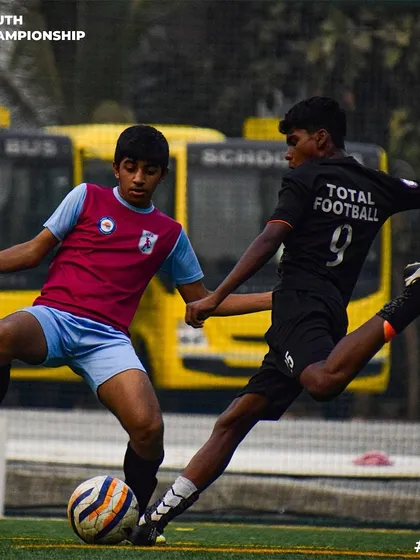 Full contact football. A player makes a crucial tackle to win back possession.